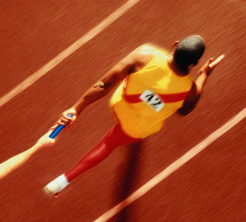 Man running who has just been passed the baton